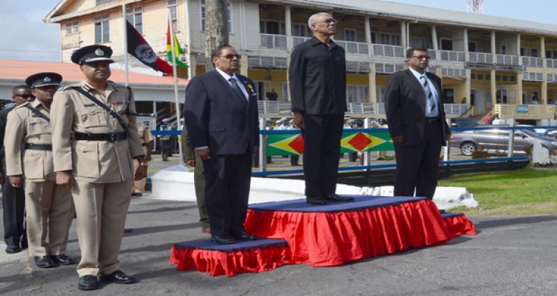 President David Granger taking the salute at the opening of the Annual Police Officers’ Conference yesterday. next to him are Prime Minister Moses Nagamootoo, Minister of Public Security Khemraj Ramjattan and Police Commissioner Seelall Persaud