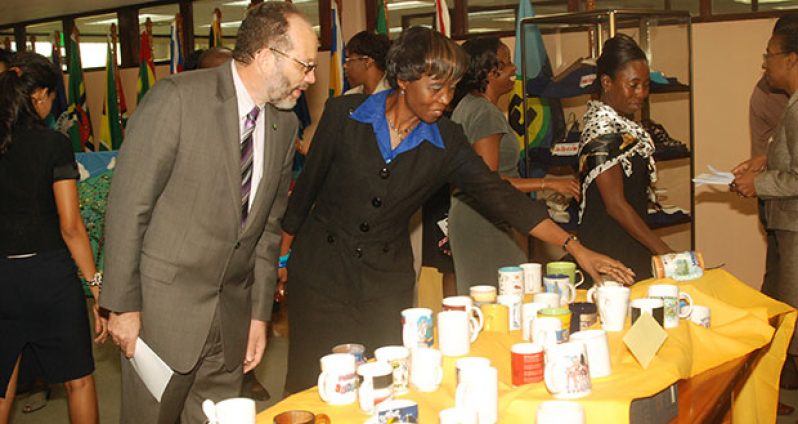 CARICOM Secretary-General, Ambassador, Irwin LaRocque, observing a display