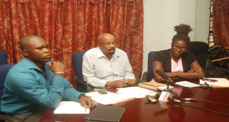 Local Government and Regional Development Minister Norman Whittaker with Municipal Services Officer Fabian Jerrick (left), and Deputy Permanent Secretary of the Local Government Ministry, Abena Moore (right)