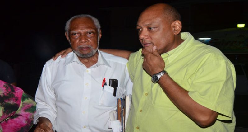 Raphael Trotman comforts his father, Donald Trotman, still shaken after the ordeal.