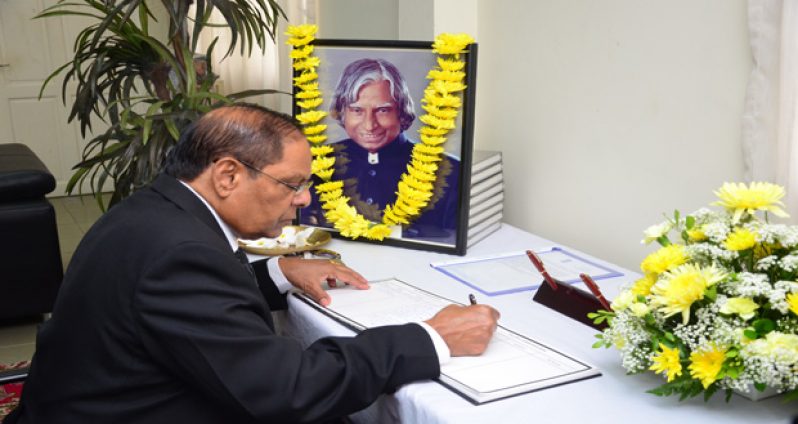 Prime Minister Moses Nagamootoo signing the book of condolences for Dr. Abdul Kalam