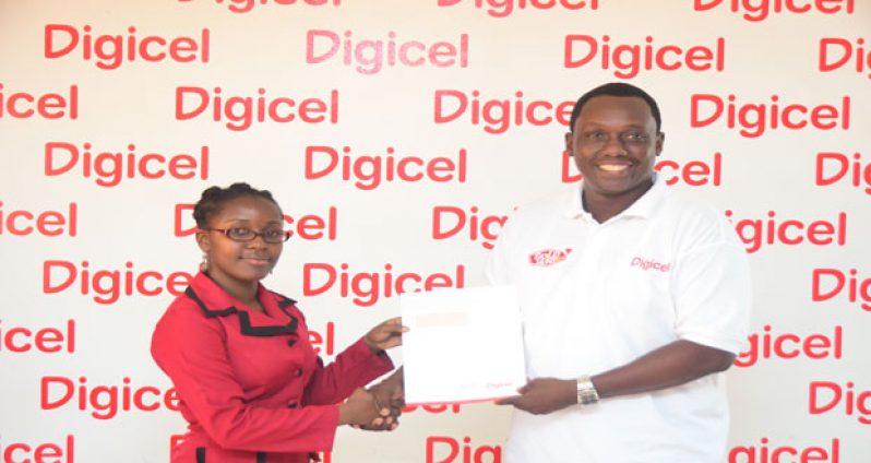Digicel Events and Sponsorship Manager Gavin Hope as he presented the cheque to Youth Advisor of Hope Foundation, Carol Livan, yesterday morning.