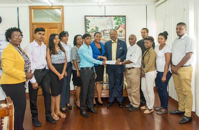 Senior Members of the University of Guyana administration and students affected by the Cummings Lodge apartment fire at the presentation ceremony on Wednesday