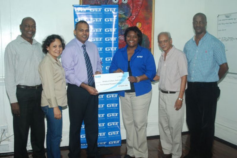 Dr Frank Anthony receives the sponsorship cheque of $500, 000 from GT&T Public Relations Officer (PRO), Ms Allison Parker