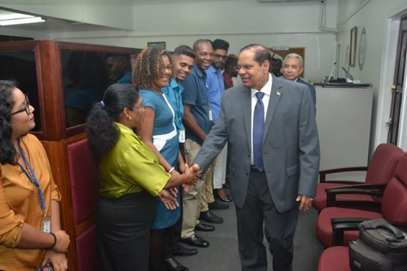 Prime Minister Moses Nagamootoo greeting staff at his office.