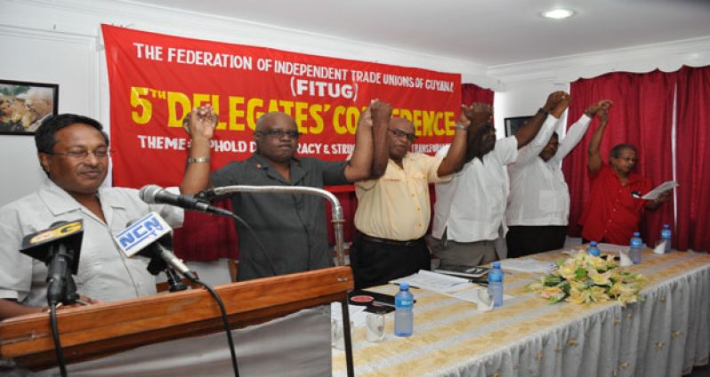 Members of the head table take part in singing ‘Solidarity Forever’