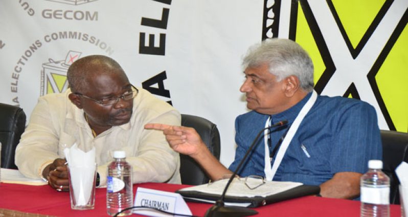 GECOM’s CEO, Keith Lowenfield, left, and GECOM Chairman, Dr Steve Surujbally, in a brief exchange during yesterday’s news conference