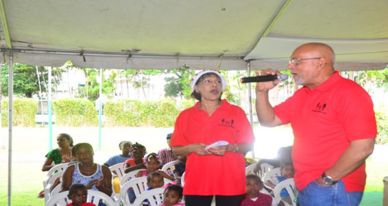 President Donald Ramotar and First Lady, Madame Deolatchmee Ramotar having a time of their lives, as they lead the children in the singing of traditional Christmas Carols (Photo by Adrian Narine)