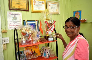 Brahash Dyaram displaying some of her certificates, awards, and trophies in her home for her excellence in service to society (Carl Croker photos)