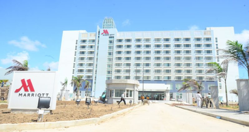 ‘ALMOST COMPLETE’: The welcoming entrance to the Marriott Hotel yesterday, even as workers press ahead with the landscaping and other finishing touches ahead of next month’s grand opening (Vishwanauth Narine photo)