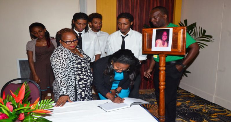 The Y3K siblings pose with Fly Jamaica Marketing Representative Wesley Tucker and Dr. Dawn Stuart-Lyken as Tiffany Johnson signs the Book of Condolences for the late Dr. Faith Harding (Photo by Adrian Narine)