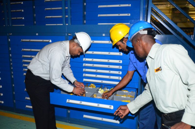 Asif Sahid, Macorp’s Parts Manager and staff sort Caterpillar Parts