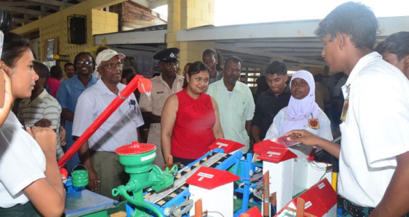 A student from Abram Zuil Secondary explains to Minister Priya Manickchand what their project is about.