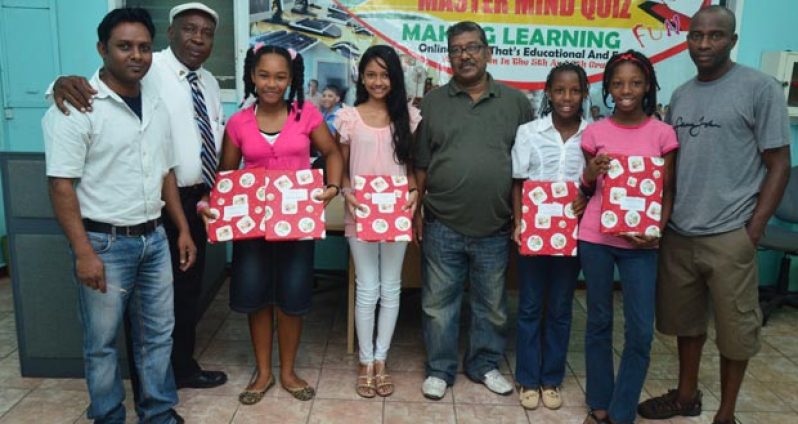 GNNL General Manager Nandkumar Puran (centre) Production Manager Samuel Bynoe (extreme right) and Mastermind Quiz Coordinator, Akash Persaud (extreme left) and second from left Chronicle’s Chief Photographer Cullen Bess-Nelson with the winners.(Adrian Narine photo)