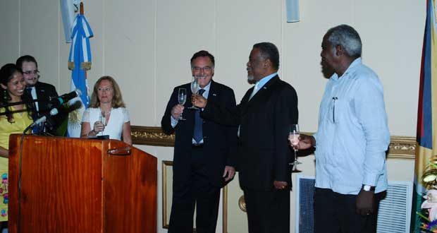 Ambassador of the Republic of Argentina, Mr. Luis Martino, and Guyana’s Prime Minister Samuel Hinds share a toast to celebrate Argentina’s 204th anniversary of the 1810 May Revolution, which paved the way for the South American nation’s independence. Also in photo is Minister Robeson Benn