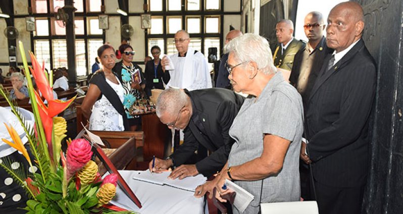 President David Granger signs the book of condolence for the late Bishop George