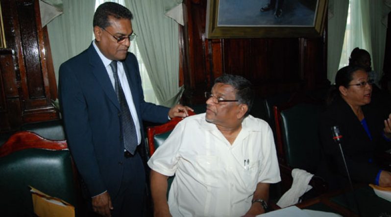Labour Minister Dr Nanda Goapaul (seated) in conversation with former Labour Minister Manzoor Nadir in the National Assembly yesterday.