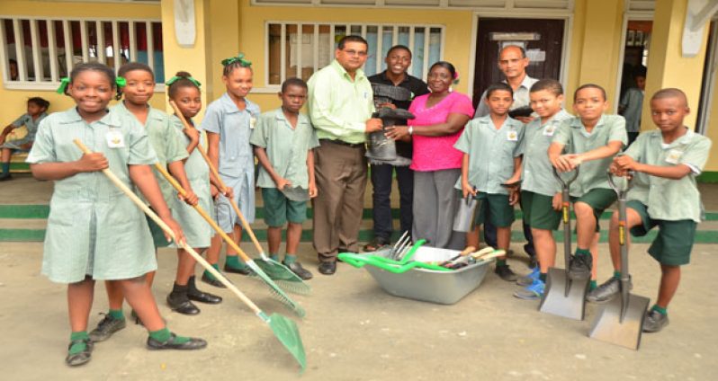 GTA’s Director Indranauth Haralsingh hands over tools to Clive Muridalall, Georgina Lewis and some of the members of St. Margaret’s Primary School ECHO club (Photos by Adrian Narine)