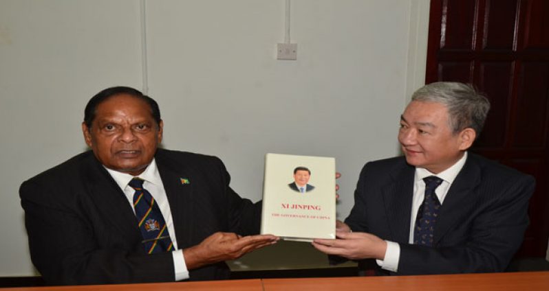 Chinese Ambassador to Guyana, H.E. Zhang Limin presenting a
copy of the work done by China’s President Xi Jinping to Prime Minister, Moses Nagamootoo, yesterday (Adrian Narine photo)