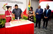 President Irfaan Ali (second from left) and Ambassador Guo Haiyan (first from left) cut the ceremonial cake as Foreign Affairs Minister Hugh Todd (first from right), Prime Minister Mark Phillips Mark Phillips (second from right) and Mrs Mignon Phillips look on. (Carl Croker photo)