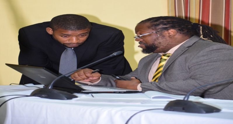 Attorney-at-Law and counsel for the former PNC Government, Selwyn Pieters (sitting); in conversation with Attorney-at-Law and counsel for the GTUC, Brian Clarke