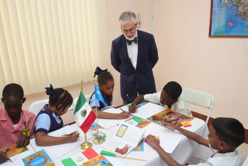 Mexican Ambassador to Guyana, Mr. Francisco Olguín, overlooks pupils engaged in the art exercise
