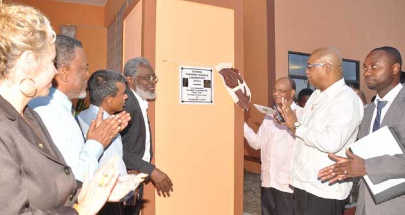 During the ceremonial unveiling of the plaque yesterday by Head of the Presidential Secretariat, Dr. Roger Luncheon, fourth left. Cheering him on are IDB (Inter-American Development Bank) Resident Representative, Ms. Sophie Makonnen and Prime Minister, Mr. Samuel Hinds, first and second left, respectively; and Minister of Home Affairs, Mr Clement Rohee, and Junior Minister of Finance, Bishop Juan Edghill, third and second right, respectively (Photo by Delano Williams)