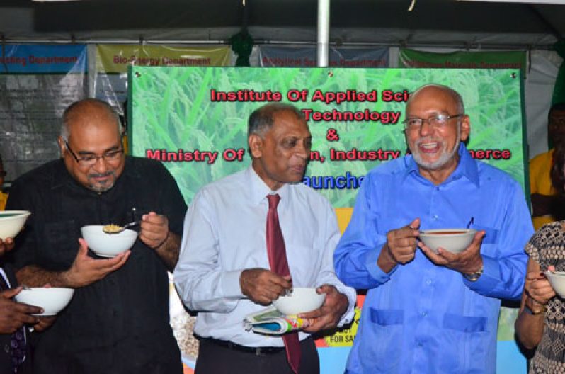 President Ramotar (far right)Dr Suresh Narine (left), Agriculture Minister Dr Leslie Ramsammy (centre) seem to be relishing the rice cereal on Thursday at the opening of guyExpo (Adrian Narine photo)