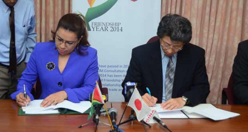 Sealing the deal are, from left, Guyana’s Foreign Minister, Ms Carolyn Rodrigues-Birkett, and  Japan’s Ambassador to Guyana, Mr Yoshimasa Tezuka