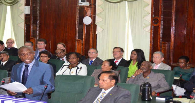 Foreign Affairs Minister Carl Greenidge updating the House this past week. Venezuelan Ambassador to Guyana, Reina Diaz, is seated at far right in photograph