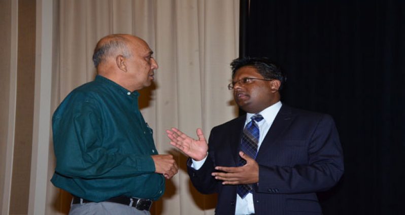 Finance Minister Dr Ashni Singh in discussion with Howard Bulkan following the GMSA forum (Photo by Adrian Narine)