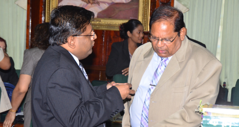 ‘TRYING TO FIND COMMON GROUND’: Finance Minister Dr Ashni Singh and AFC Executive Member Moses Nagamootoo in the National Assembly on Thursday.