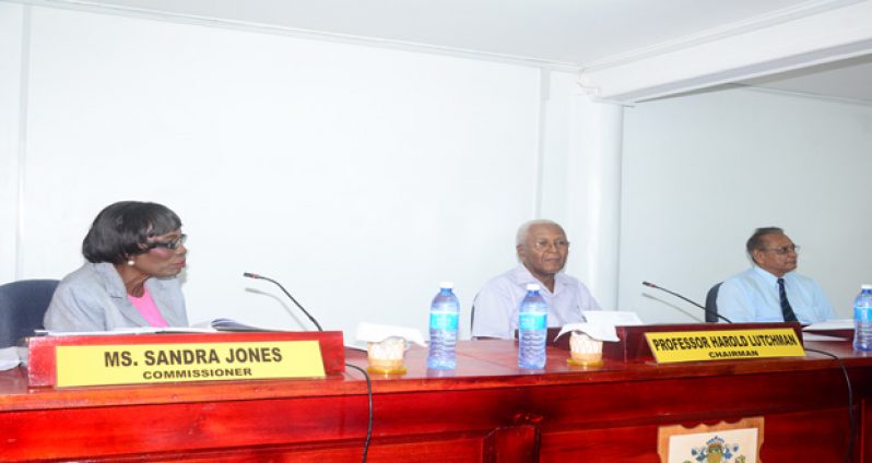 Chairman of the CoI Professor Harold Lutchman (seated centre) flanked by Commissioners Sandra Jones and Samuel Goolsarran