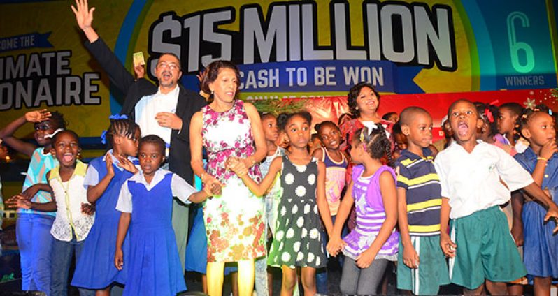 Clyde de Haas, Managing Director of Courts (Guyana); First Lady Deolatchmee Ramotar and Education Minister Priya Manickchand. singing some Christmas carols with the children