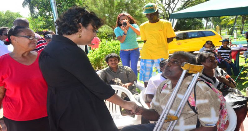 Education Minister, Priya Manickchand interacts with one of the PWDs