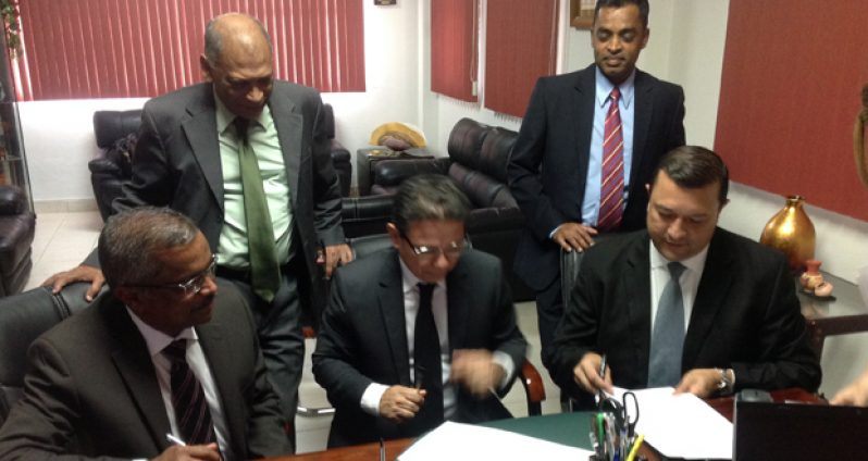 Seated from left: GRDB General Manager, Mr. Jagnarine Singh, Director General of Panama’s Institute of Agriculture Marketing, Mr. Edwin Cardenad signing the rice sales contract. Standing, from left, are Agriculture Minister, Dr. Leslie Ramsammy and RPA General-Secretary, Dharamkumar Seeraj