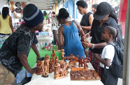 A craftsman telling persons about his creations