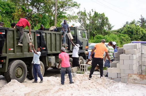 Officials of the M&CC removing the construction materials belonging to proprietor of Stain Masters, Anthony Noble. [Samuel Maughn photo]