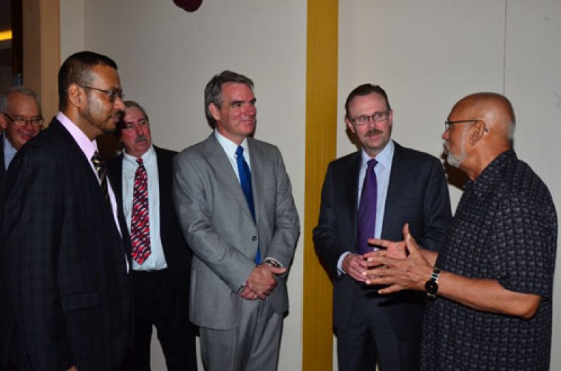 President Donald Ramotar and Natural Resources Minister, Robert Persaud, at left, engaging with representatives of Exxon Mobil