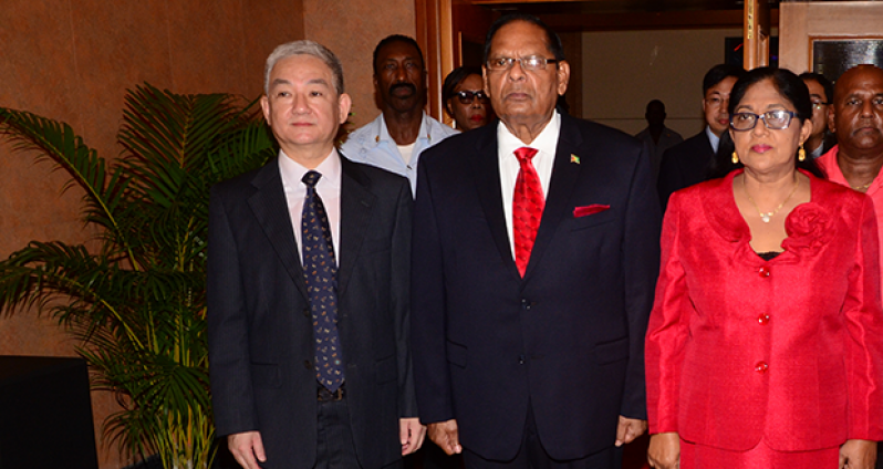 Acting President Moses Nagamootoo and his wife Sita Nagamootoo with Chinese Ambassador to Guyana Zhang Limin on their arrival at the Independence reception (Adrian Narine Photo)