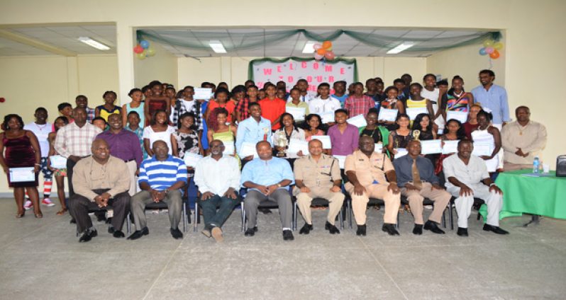 The graduates pose with ‘Top Cop’ Seelall Persaud, senior officers and others (seated in front row) following the graduation ceremony