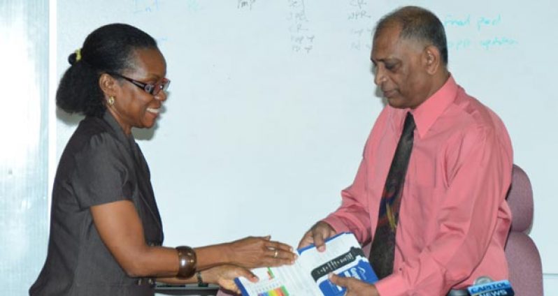 Dr. Fletcher-Paul as she handed over the Guyana UN-Water Country Brief to Minister Ramsammy on Wednesday.