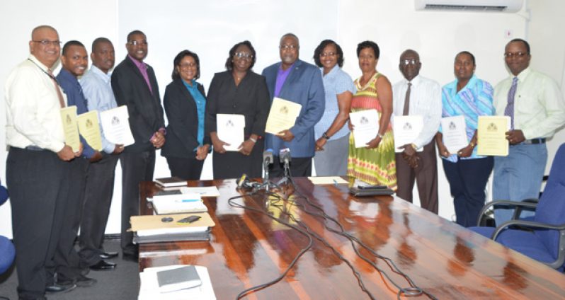 Government ministers share a moment with the newly-appointed Guyana Post Office Corporation Board members