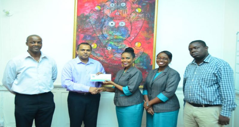 Minister Anthony (centre) receives the $2.8M cheque from Republic Bank representatives (Photo by Adrian Narine)