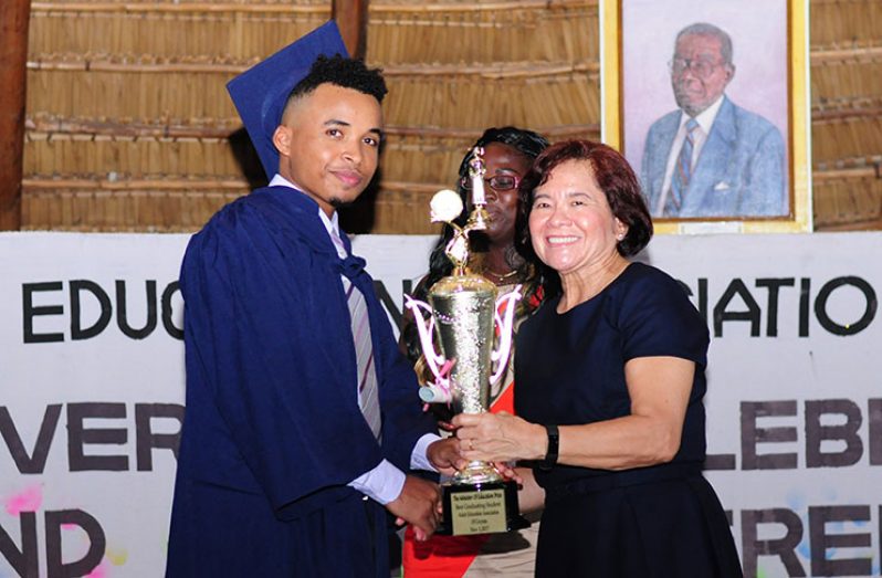 First Lady, Mrs. Sandra Granger presents the coveted trophy  to Valedictorian,  Shaquille Nurse