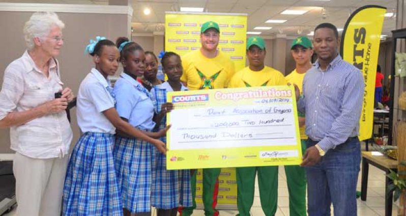 L-R President of DAG Sabine McIntosh, students of DAG, Amazon Warriors cricketers Martin Guptill, Leon Johnson and  Tagenarine Chanderpaul, and Marketing Manager of Courts Guyana Pernell Cummings.
