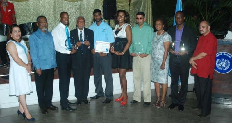 Prime Minister, Mr. Samuel Hinds (second left) and UN Resident Representative, Ms. Khadijda Musa (third right), along with  Minister of Foreign Affairs, Ms. Carolyn Rodrigues-Birkett (left) and Minister of  Health, Dr. Bheri Ramsaran (right), pose with winners of the MDG Champions Awards. Fourth left is Justice Donald Trotman, winner of UN Special Recognition Award (Photo by Cullen Bess-Nelson)