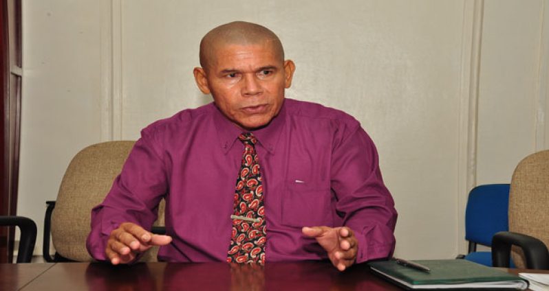 Minister of Health Dr. George Norton speaking during an interview with the Guyana Chronicle.