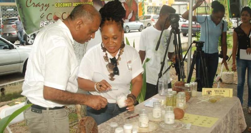 Agriculture Minister, Dr. Leslie Ramsammy, samples one of the items in the line of products offered by ‘Crazy4Coconuts’