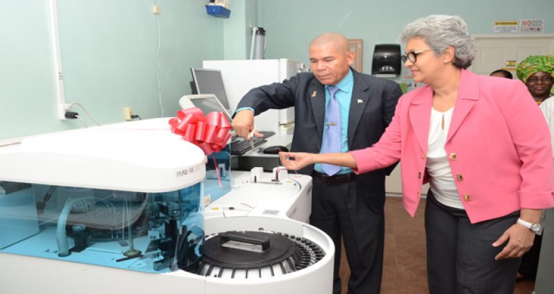 Dr. Norton and Dr. Singh cutting the ceremonial ribbon to christen the analysers (Photo by Delano Williams)